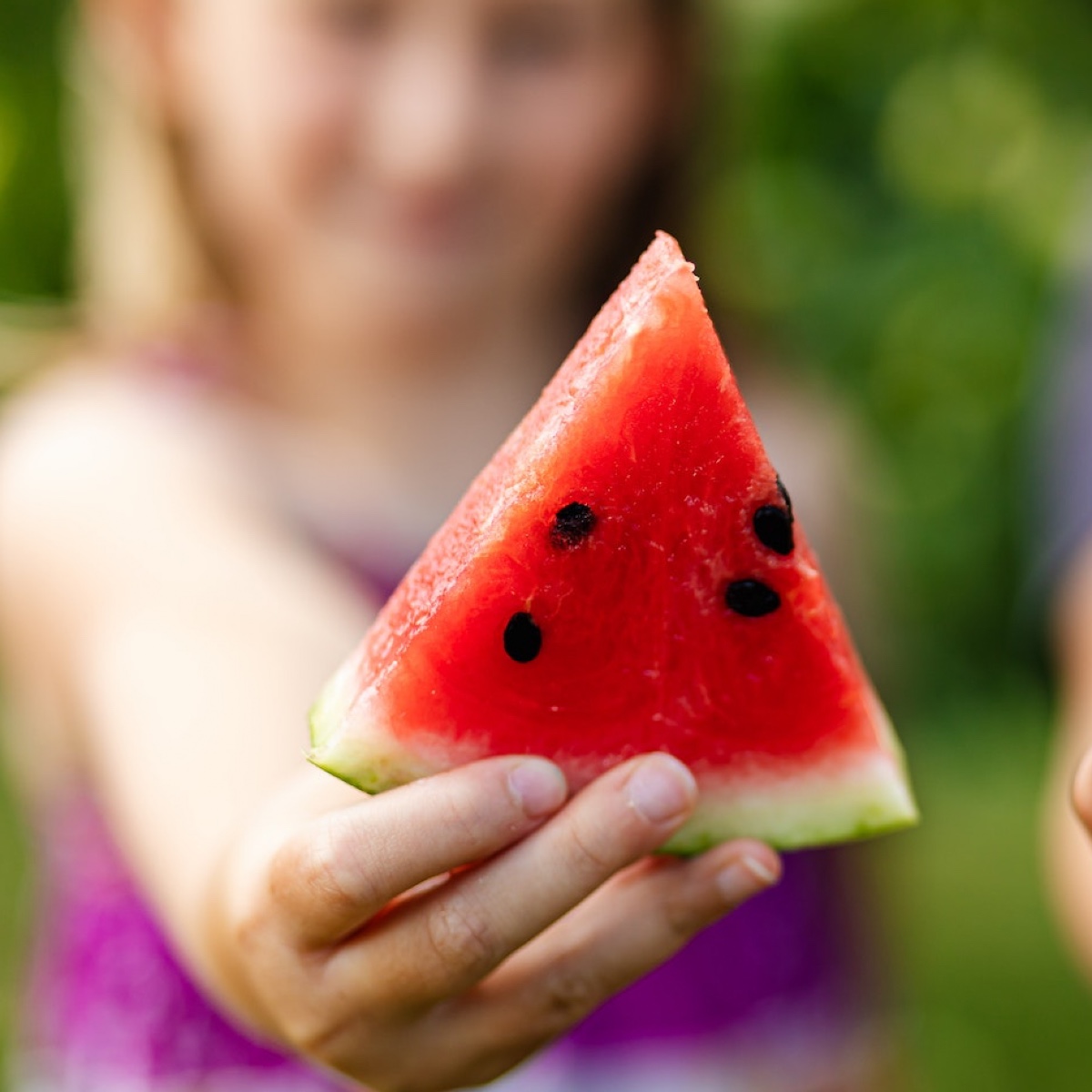 Child holding a watermelon slice