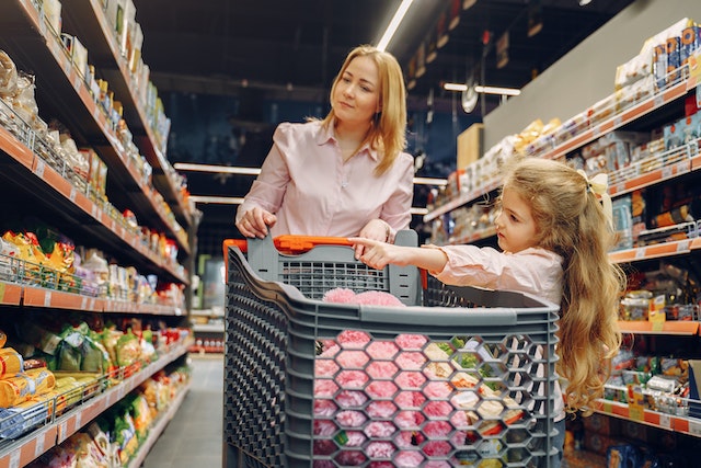 A mother and child shopping together at the supermarket