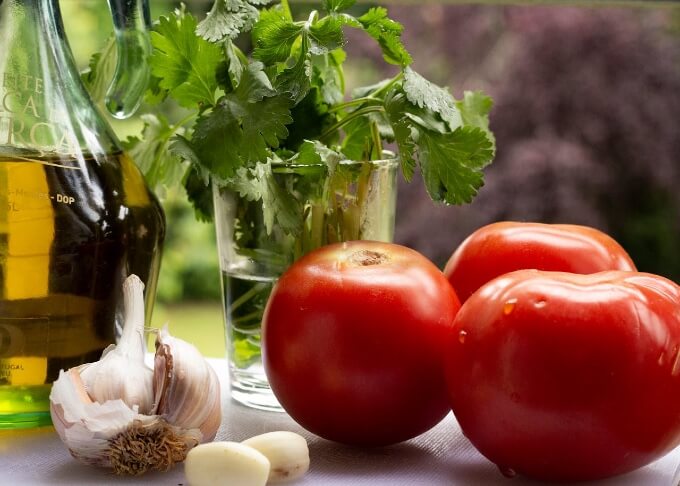 tomatoes, olive oil and garlic and herbs close up