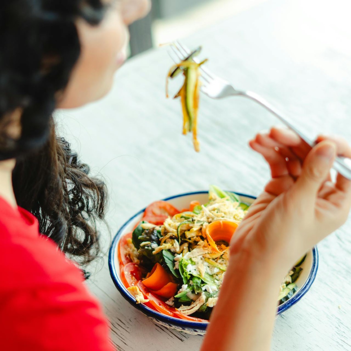 Woman eating a healthy meal at a table